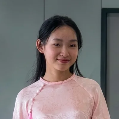 Lucky, Miss Saigon Tours guide, in a pink ao dai at a Saigon metro station